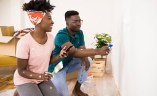 couple painting the wall in living room