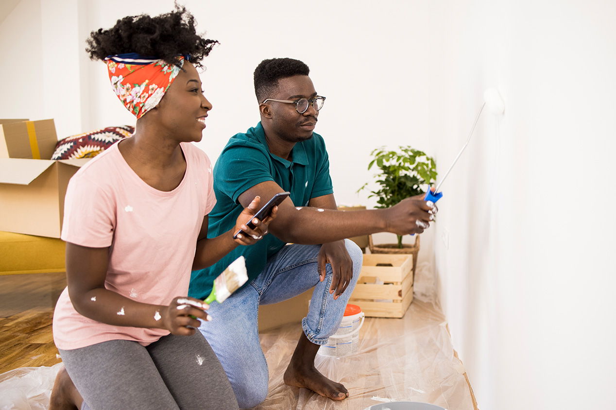 couple painting the wall in living room