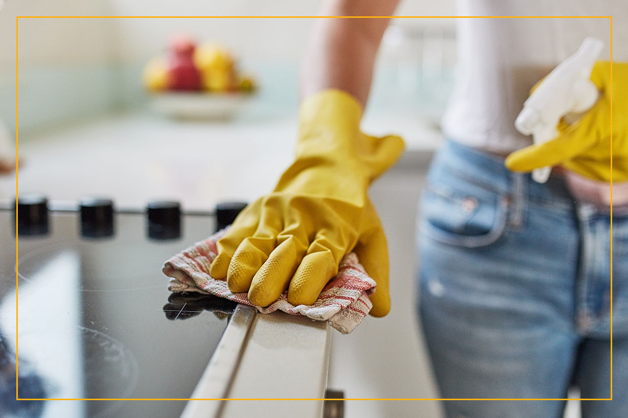 Person in rubber gloves cleaning counter tops