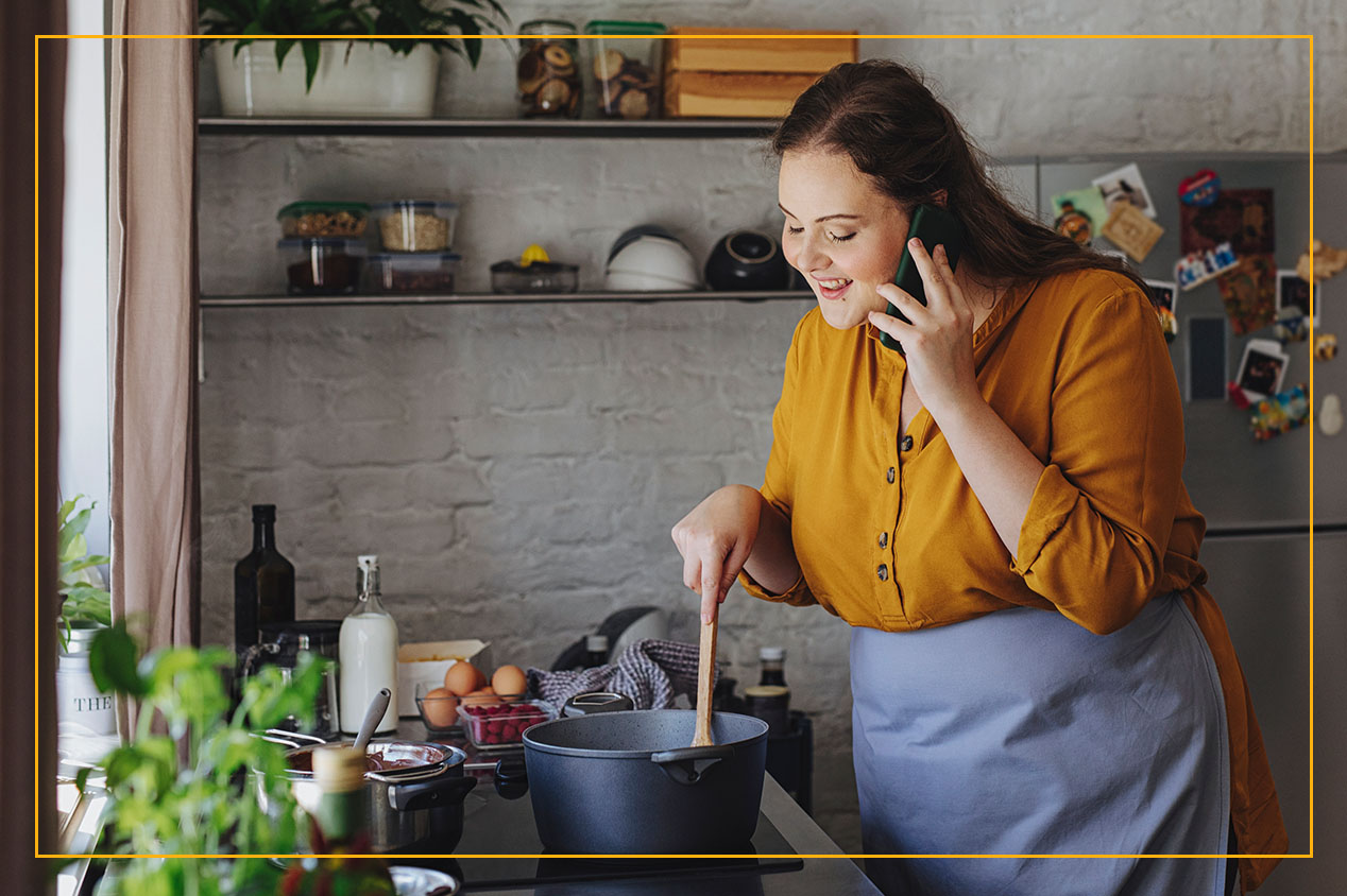 woman stirring a pot on a kitchen stove