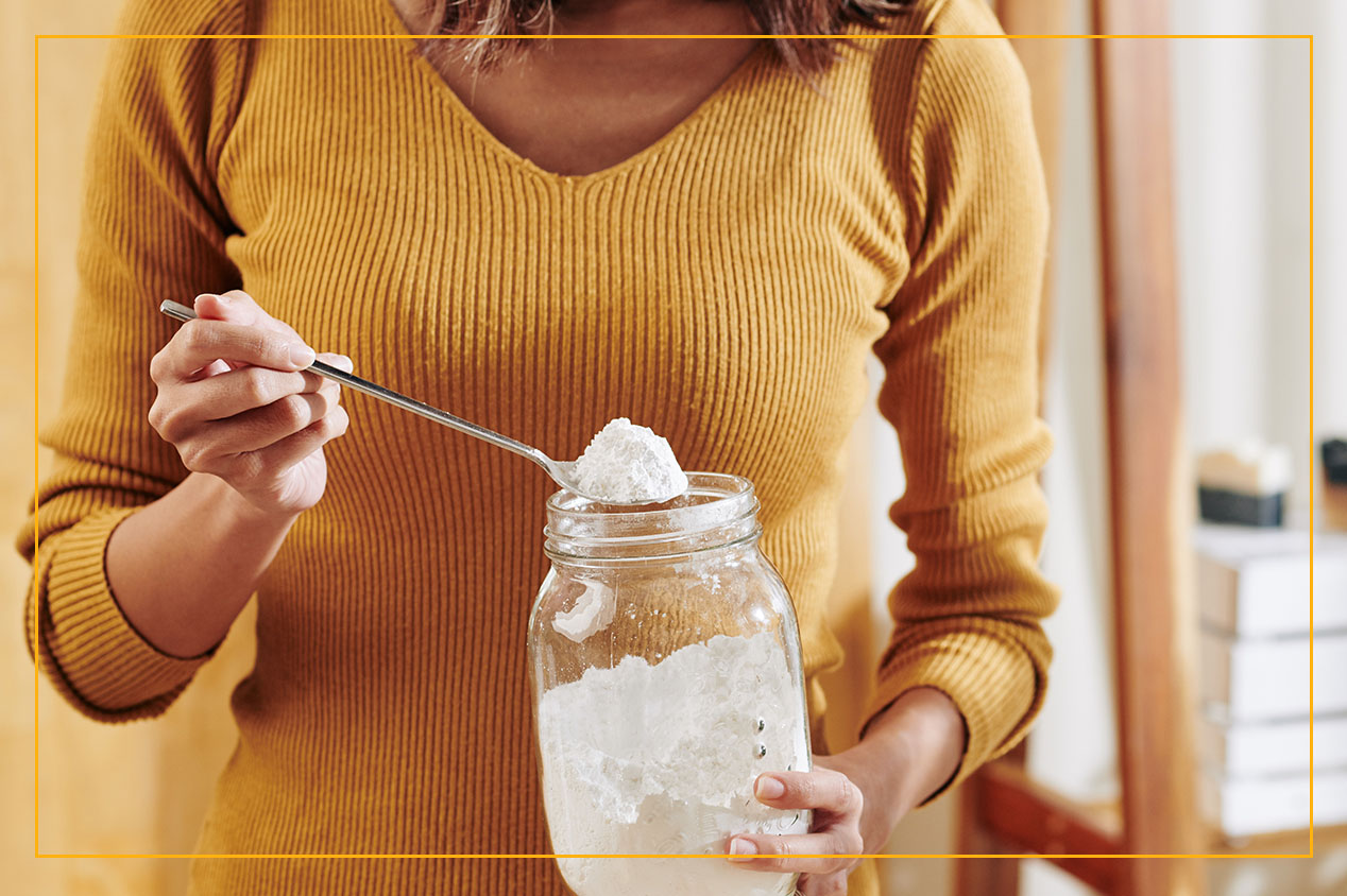 woman scooping up baking soda