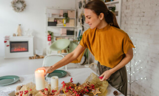 Woman setting down candle on table