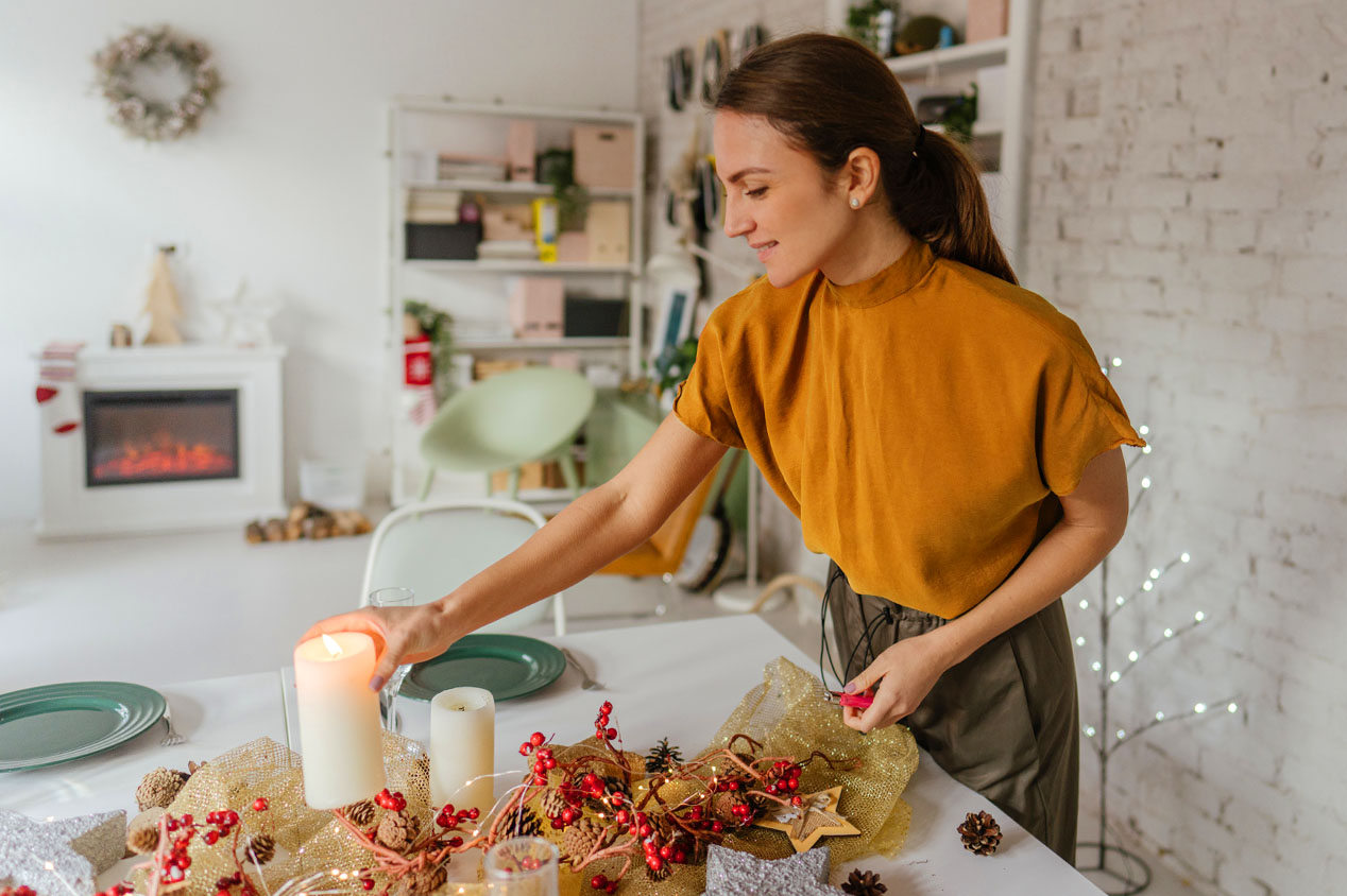 Woman setting down candle on table