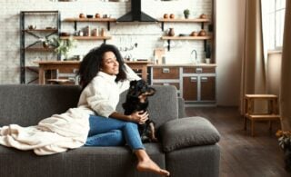 Woman sitting in the living room with her dog