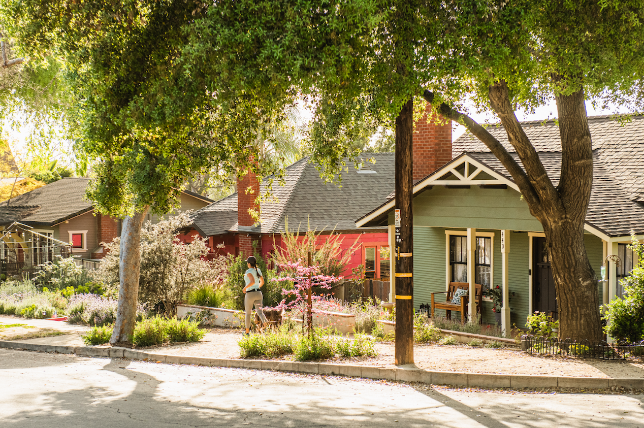 suburban neighborhood with woman running